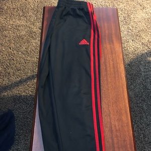 Red stripe adidas joggers.